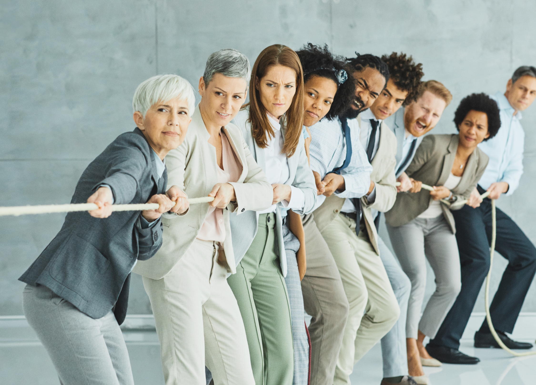 diverse people pulling a rope together